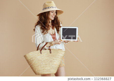 smiling woman in blouse and shorts digital tablet blank screen 112368827