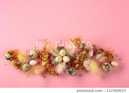 Easter composition with quail eggs, feathers, and dried flowers. Easter composition with quail eggs, feathers, and dried flowers. 112369025