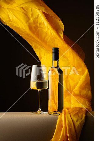 White wine and flutters of yellow cloth. White wine and flutters of yellow cloth. 112369288