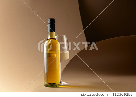 Bottle and glass of white wine. 112369295