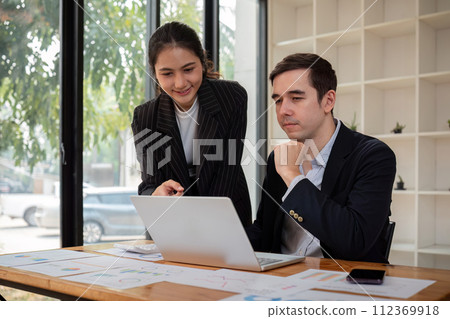 Team business of diverse partner business woman discuss project on laptop sitting at table in office. Two colleague of professional business people working together 112369918