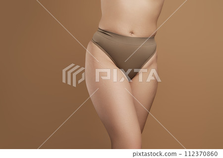 Cropped image female body in green underwear 112370860