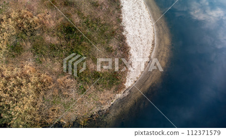 Aerial look down on river dark water surface 112371579