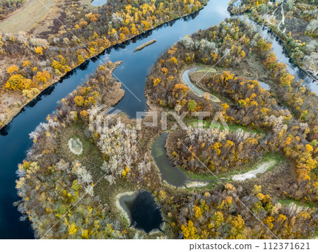 Autumn aerial look down on golden river valley 112371621