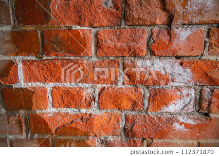 Brick wall with rough repairs 112371870