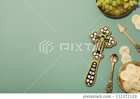 Liturgical bread, cross and grapes on green background, space for text Liturgical bread, cross and grapes on green background, space for text 112372120