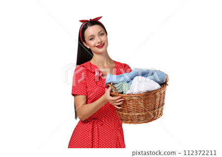 A girl, a housewife, with a basket of laundry. A girl, a housewife, with a basket of laundry. 112372211