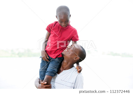 happy family, father and son strolling together outdoors 112372446