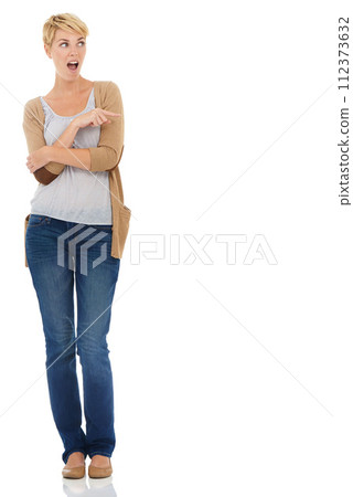 Happy woman, surprise and pointing on mockup space for advertising on a white studio background. Female person or blonde in shock, fashion or casual clothing showing deal, marketing or special offer 112373632