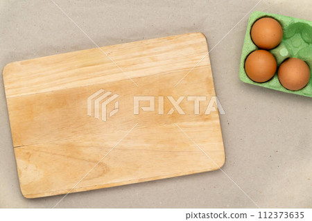 Green carton of eggs and cutting board. Easter background Green carton of eggs and cutting board. Easter background 112373635