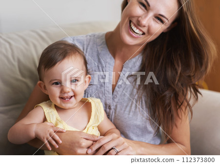 Mother, baby and smile in portrait at home, love and together for bonding in childhood. Mommy, daughter and support for happy toddler in child development, mama and security or connection on sofa 112373800