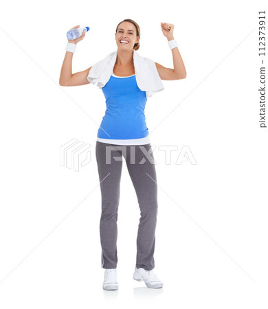 Woman, fist and water bottle for fitness in studio with exercise, workout success or body goals and achievement. Portrait of model with fist, energy and training celebration on a white background Woman, fist and water bottle for fitness in studio with exercise, workout success or body goals and achievement. Portrait of model with fist, energy and training celebration on a white background 112373911