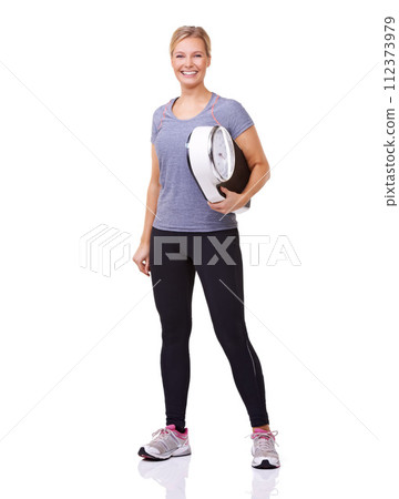 Exercise, scale and portrait of woman with smile, workout and wellness with healthy pride in studio. Health, fitness and body of happy girl with weight loss measurement isolated on white background. Exercise, scale and portrait of woman with smile, workout and wellness with healthy pride in studio. Health, fitness and body of happy girl with weight loss measurement isolated on white background. 112373979