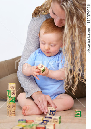 Mother, baby and playing with wooden blocks or toys for childhood development or bonding at home. Mom, toddler and little boy learning shapes, letters or building together for fun activity at house Mother, baby and playing with wooden blocks or toys for childhood development or bonding at home. Mom, toddler and little boy learning shapes, letters or building together for fun activity at house 112374016