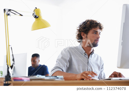 Computer, serious and business man programming, working or planning project in creative startup office. Desktop, professional and developer at table for information technology, software and coding 112374078