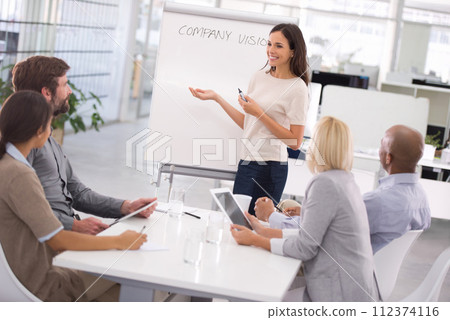 Businesswoman, presentation and training meeting with project planning or company vision, growth or coaching. Female person, colleagues and tablet or brainstorming for proposal, future or startup 112374116