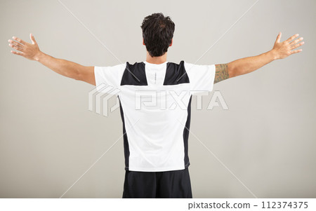 Back, athlete or man for fitness results, wellness and health isolated on grey background in studio. Arms out, model or male person with progress in exercise, workout and training on a backdrop alone 112374375