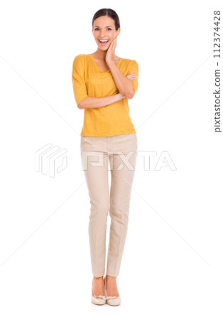 Woman, fashion and portrait for beauty, excited and happy in outfit in studio for minimalist style. Female person, smile and yellow top by white background, hand on face and confident in apparel 112374428