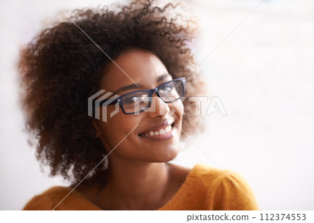 Woman, portrait and smile with confidence or glasses with positive good mood, cheerful or white background. Female person, student and eyewear for vision with curly hair or relaxed, happiness or calm 112374553