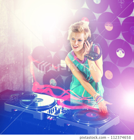 Woman dj, headphones and listen in night club for party with turntable, neon lights and lens flare. Gen z female person, smile or mixing decks at event with happy, techno and music in Berlin disco Woman dj, headphones and listen in night club for party with turntable, neon lights and lens flare. Gen z female person, smile or mixing decks at event with happy, techno and music in Berlin disco 112374658