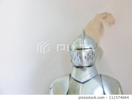 Knight, medieval suit and armor with mockup space of soldier, statue or honor on a gray studio background. Helmet, gear or equipment for battle, war or security in justice, shining silver or visor Knight, medieval suit and armor with mockup space of soldier, statue or honor on a gray studio background. Helmet, gear or equipment for battle, war or security in justice, shining silver or visor 112374664