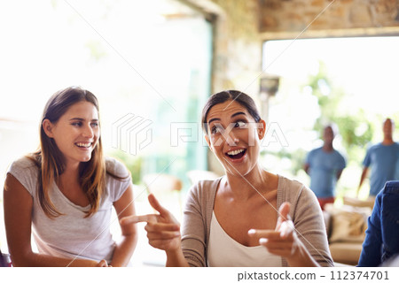 Smile, funny face and conversation with friends in restaurant together for social gathering or bonding. Happy, facial expression and hand gesture with woman talking to group of people in coffee shop 112374701