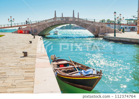 Bridge over canal and exit to bay in Venice Bridge over canal and exit to bay in Venice 112374764