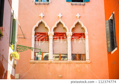 Windows on red wall in old house Windows on red wall in old house 112374774