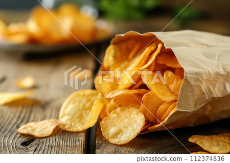 Potato chips, slice deep fried snack fast food in open bag. Potato chips, slice deep fried snack fast food in open bag. 112374836