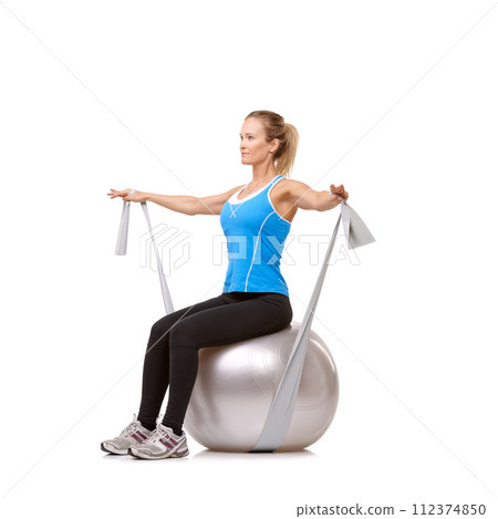 Exercise ball, resistance band and woman doing workout in studio for health, wellness and body care. Sports, fitness and female person from Canada stretching arms or training by white background 112374850