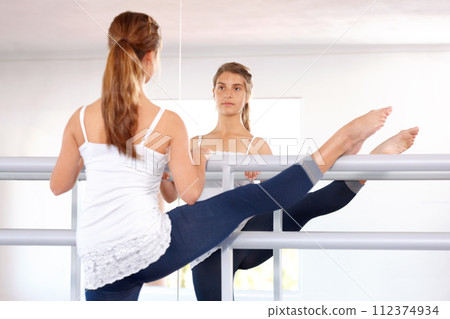 Stretching legs, ballet and reflection of girl in studio, barre and student exercise. Ballerina, young teenager and mirror for flexibility training, dance choreography for performance art and fitness 112374934