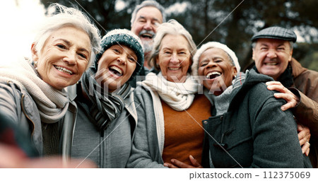 Happy, selfie and senior friends in a park while walking outdoor for fresh air together. Diversity, smile and group of elderly people in retirement taking picture and bonding in a forest in winter. Happy, selfie and senior friends in a park while walking outdoor for fresh air together. Diversity, smile and group of elderly people in retirement taking picture and bonding in a forest in winter. 112375069