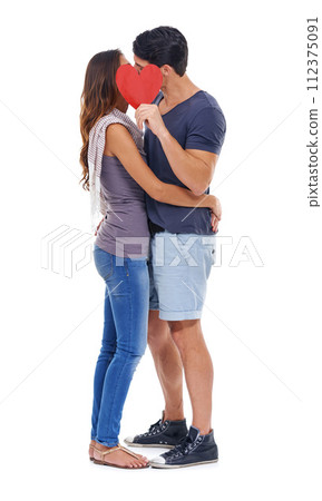 Kissing, paper and heart with couple, love and marriage isolated on white studio background. Face, man and woman with date, hug or symbol with romance or Valentines day with relationship or embrace 112375091