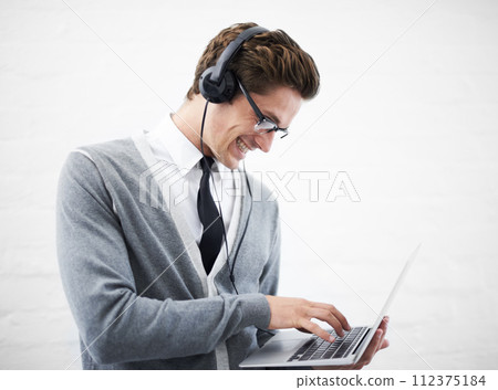 Happy man, laptop and headphones listening to music, audio or streaming on a gray studio background. Male person, nerd or geek smile with computer and headset for sound or podcast on mockup space Happy man, laptop and headphones listening to music, audio or streaming on a gray studio background. Male person, nerd or geek smile with computer and headset for sound or podcast on mockup space 112375184