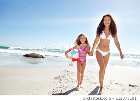 Happy mother, portrait and child with beach ball for fun summer holiday, bonding or playing in the sun. Mom holding hands with daughter or playful kid smile for weekend vacation by the ocean coast Happy mother, portrait and child with beach ball for fun summer holiday, bonding or playing in the sun. Mom holding hands with daughter or playful kid smile for weekend vacation by the ocean coast 112375191