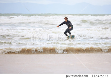 Surfer man, ocean and board with balance, fitness and training for health, wellness and freedom in summer. Person, surfing and outdoor for sports, exercise and adventure at sea, waves and sunshine Surfer man, ocean and board with balance, fitness and training for health, wellness and freedom in summer. Person, surfing and outdoor for sports, exercise and adventure at sea, waves and sunshine 112375564