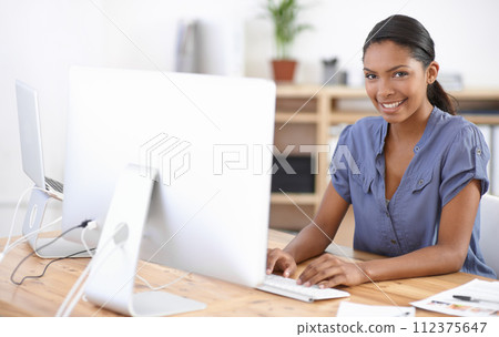 Business woman, portrait and typing at computer in office for online research, website review or planning connection in creative startup. Happy african designer, desktop and working in digital agency 112375647