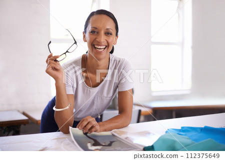 Businesswoman, fashion designer and portrait in office, workspace and studio for clothing, working or creative career. Happy female person, stylist and seamstress with magazine, fabrics or creativity Businesswoman, fashion designer and portrait in office, workspace and studio for clothing, working or creative career. Happy female person, stylist and seamstress with magazine, fabrics or creativity 112375649