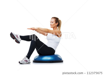 Fitness, half ball and woman in a studio for stretching body workout or training with balance. Sports, equipment and young female person with muscle warm up exercise isolated by white background. Fitness, half ball and woman in a studio for stretching body workout or training with balance. Sports, equipment and young female person with muscle warm up exercise isolated by white background. 112375675