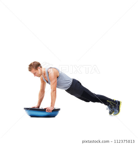 Man, push up for exercise and balance, bosu ball for core training and muscle in workout on white background. Fitness equipment, strength and endurance with mockup space and strong athlete in studio 112375813