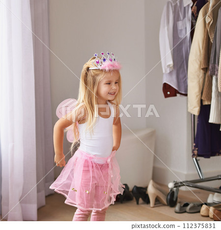 Princess, dance and portrait of girl with costume in home for fun, play or pretend for happy kids game. Fantasy, fashion and child in creative fairy fancy dress with wings, tiara and smile in bedroom 112375831