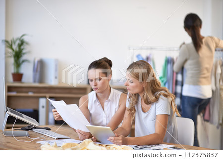 Fashion designer, teamwork and tablet for brainstorming, planning and sketch ideas, clothes production or business startup. Artist, women or people with digital technology and paper for collaboration Fashion designer, teamwork and tablet for brainstorming, planning and sketch ideas, clothes production or business startup. Artist, women or people with digital technology and paper for collaboration 112375837