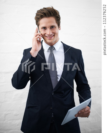 Business man, phone call and tablet with smile, portrait or contact for networking by wall background. Entrepreneur, employee or person with digital touchscreen, smartphone and happy for notification Business man, phone call and tablet with smile, portrait or contact for networking by wall background. Entrepreneur, employee or person with digital touchscreen, smartphone and happy for notification 112376252