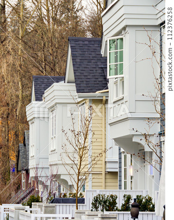 Frontside of brand new residential townhouses. Row of townhouses for sale 112376258
