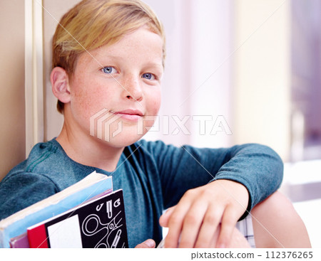 Student, portrait and boy with book in hallway with education, study and textbook for back to school. Youth, young kid and learning on ground on campus with child and happy from class and break Student, portrait and boy with book in hallway with education, study and textbook for back to school. Youth, young kid and learning on ground on campus with child and happy from class and break 112376265