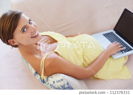 Top view, pregnant and portrait of woman on laptop for childcare, information or birth learning in house living room. Smile, happy or relax person on home sofa technology, research or pregnancy blog 112376331