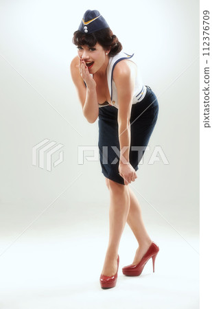 Portrait, surprise and pin up of woman flight attendant in studio on gray background for vintage fashion. Travel, wow and gossip with shocked young air hostess in work uniform for retro service 112376709