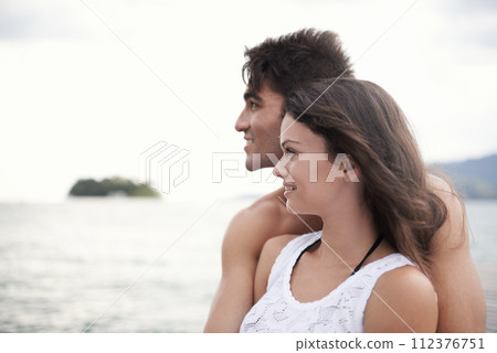 Couple, embrace and travel to ocean on vacation, love and relax by water on summer holiday. People, peace and bonding for relationship in outdoors, support and hug on weekend trip to sea or nature 112376751