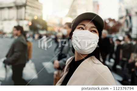 City, japan and woman in travel with face mask for health and walking in town. Covid compliance, safety for wellness and female person outdoors with facial protection for corona virus pandemic 112376794