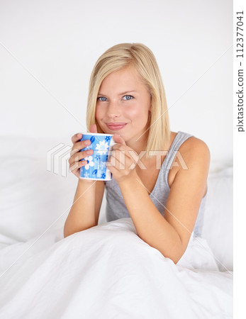 Morning, tea and portrait of woman in bed to relax in home with happiness and wellness detox. Matcha, drink and girl with smile in bedroom on holiday or vacation with health in apartment and house 112377041